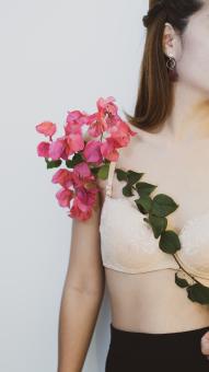 Young Beautiful Woman With Pink Flowers