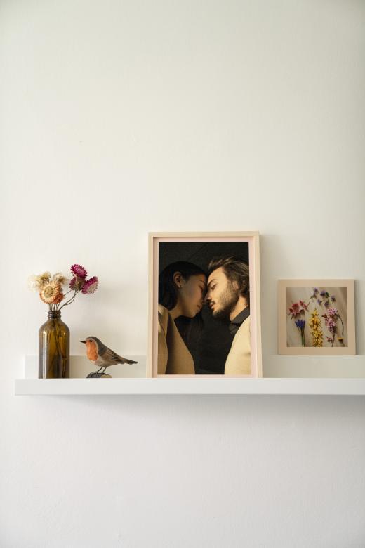 Free stock image of Framed photos on a shelf created by Vyvolej to