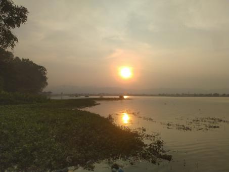 Sunset on the bank of a river - Free Stock Photo