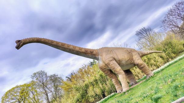 Life-Size Dinosaur Sculpture in Outdoor Park Setting