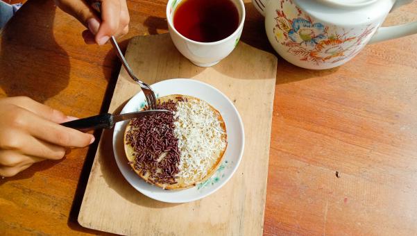 A mini photo of a martabak with a chocolate topping and grated c