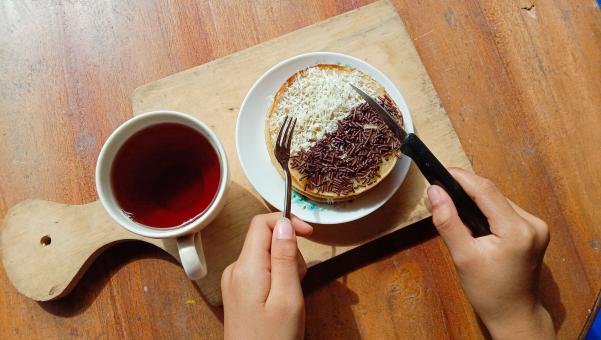 A mini photo of a martabak with a chocolate topping and grated c