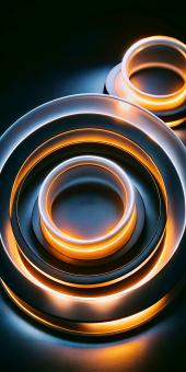 Abstract Glowing Circular Rings Illuminate a Dark Background with Warm
